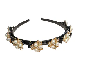 Hovedbilde H&aring;rb&oslash;yle med klips, sort og gullfarge med perler